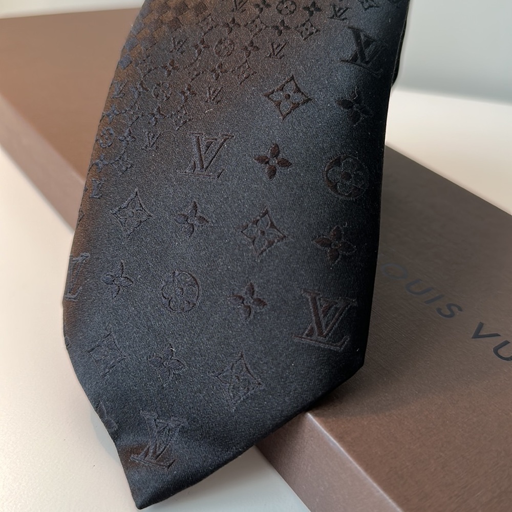 Brand New! 100% Silk tie. Louis Vuitton patterns and logos sewed into the fabric